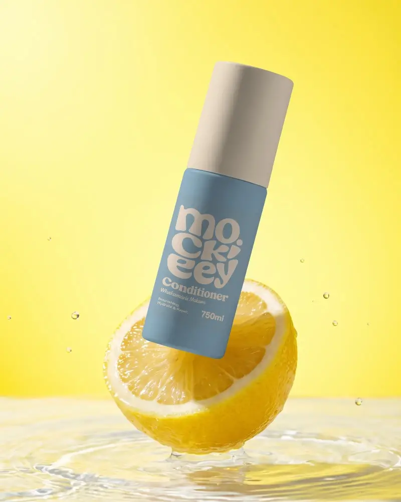 Organic Citrus Extract Cosmetic Bottle Mockup Floating On Lemon Slice Backdrop