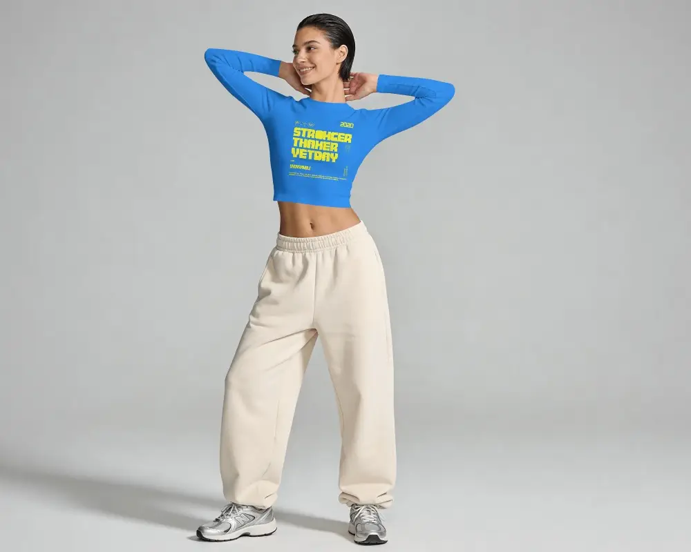 Long Sleeve Crop Top Mockup Female Model Full Body Pose In Clean Gray Studio With Athleisure Styling