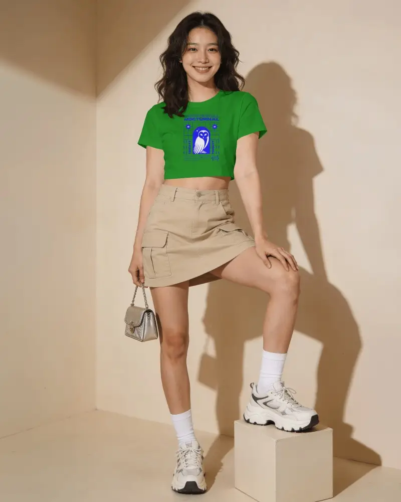 Short Sleeve Crop Top Mockup Female Model Standing In Warm Beige Corner Studio With One Foot On Cube
