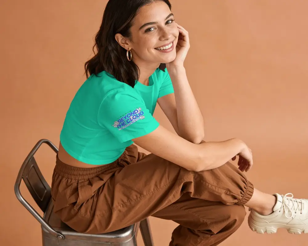 Short Sleeve Crop Top Mockup Female Model Sitting On Metal Chair In Warm Peach Studio