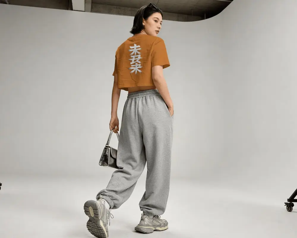 Modern Female Crop Top Mockup Posing In Minimalistic Studio Setting For Design Presentation