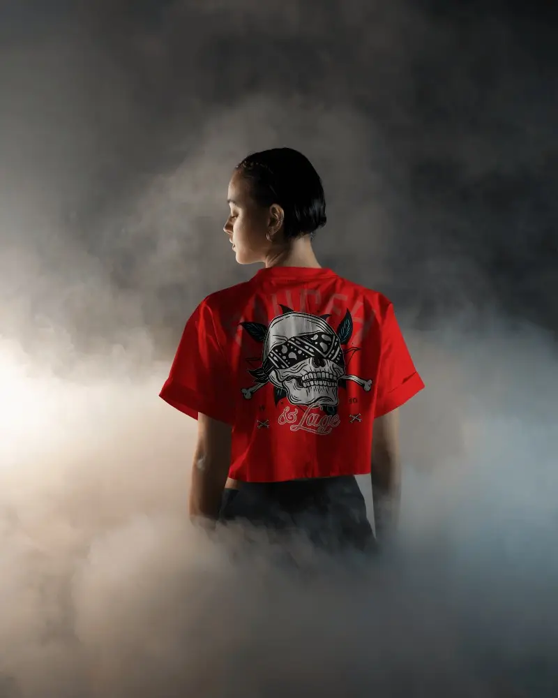 Boxy White Short Sleeve Crop Top Mockup Back View On Female Model Dramatic Smoky Background Moody Lighting Bold And Edgy Aesthetic