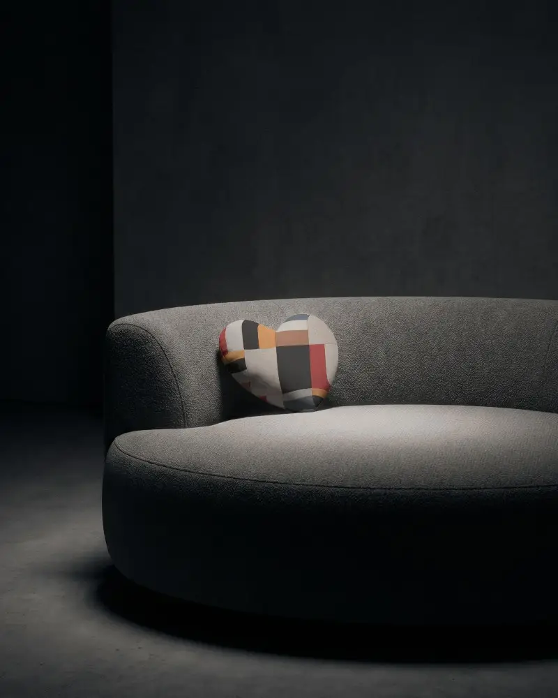 Modern Heart Shaped Cushion On Curved Sofa For Cozy Living Room Decor And Comfort