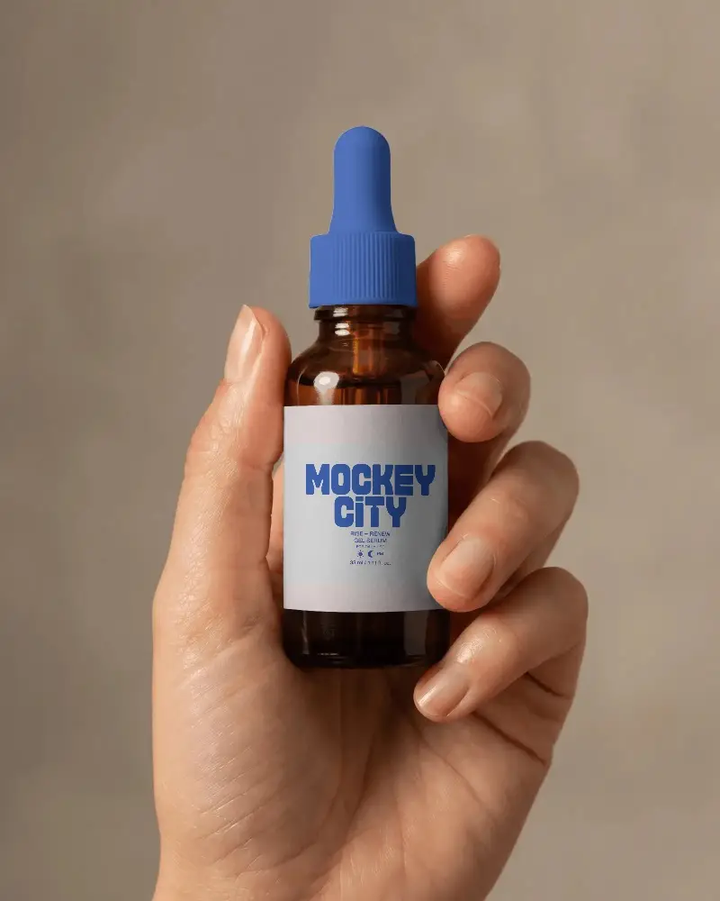 Hand Holding Dropper Bottle Mockup With Blank Label For Essential Oil Product Display