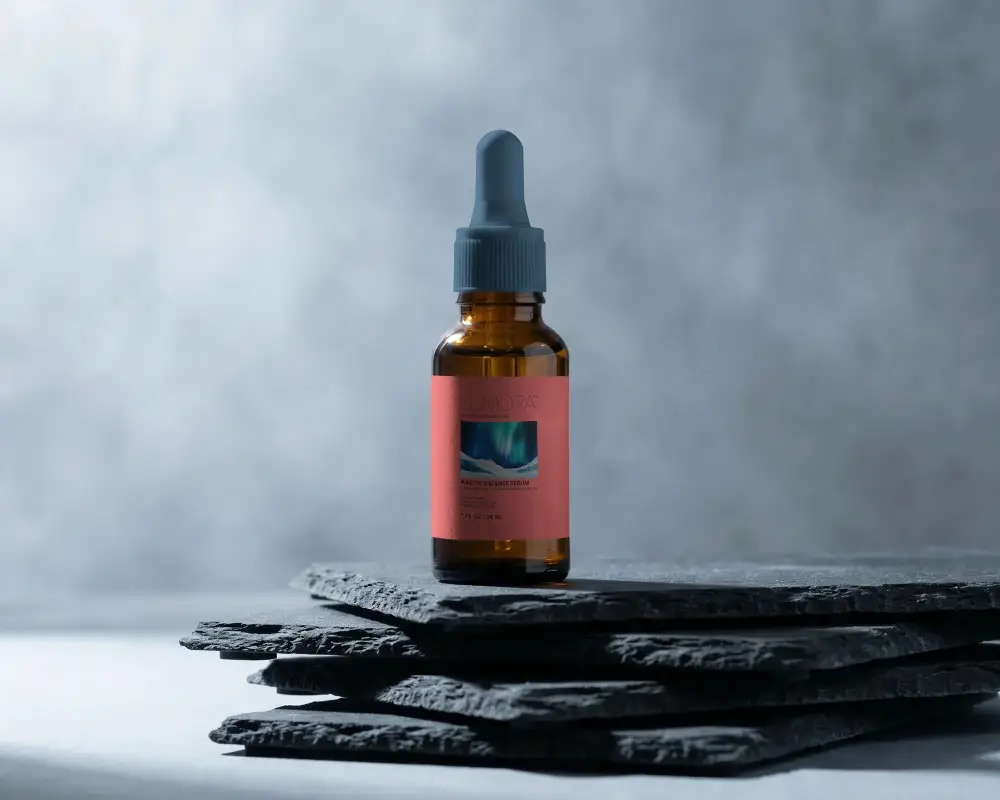 Minimalist Dropper Bottle Mockup On Stone Texture Background For Cosmetic Display