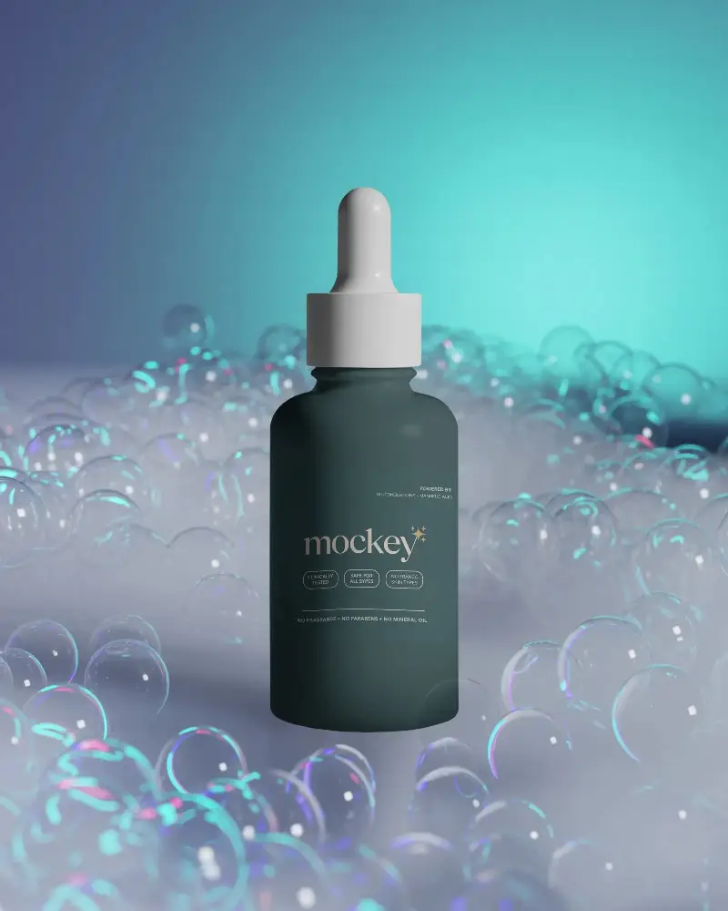 Realistic Dropper Bottle Mockup Presented On Foggy Surface With Transparent Bubble Decoration