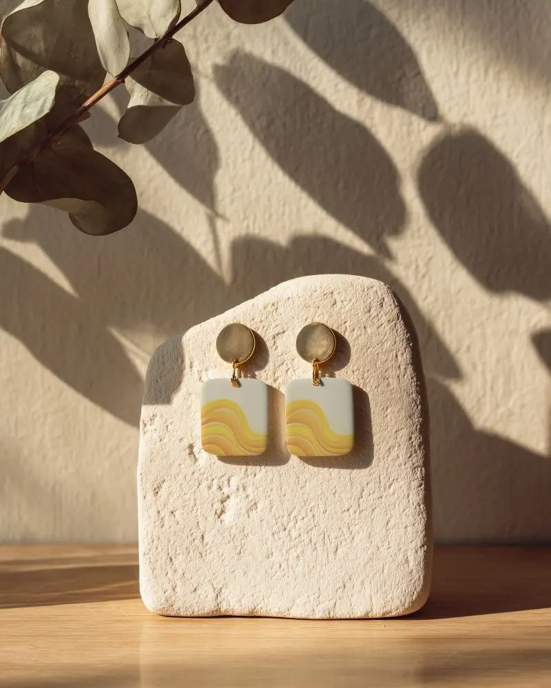 Modern Minimalist Earrings Display On Textured Stone With Natural Shadow Lighting 0163