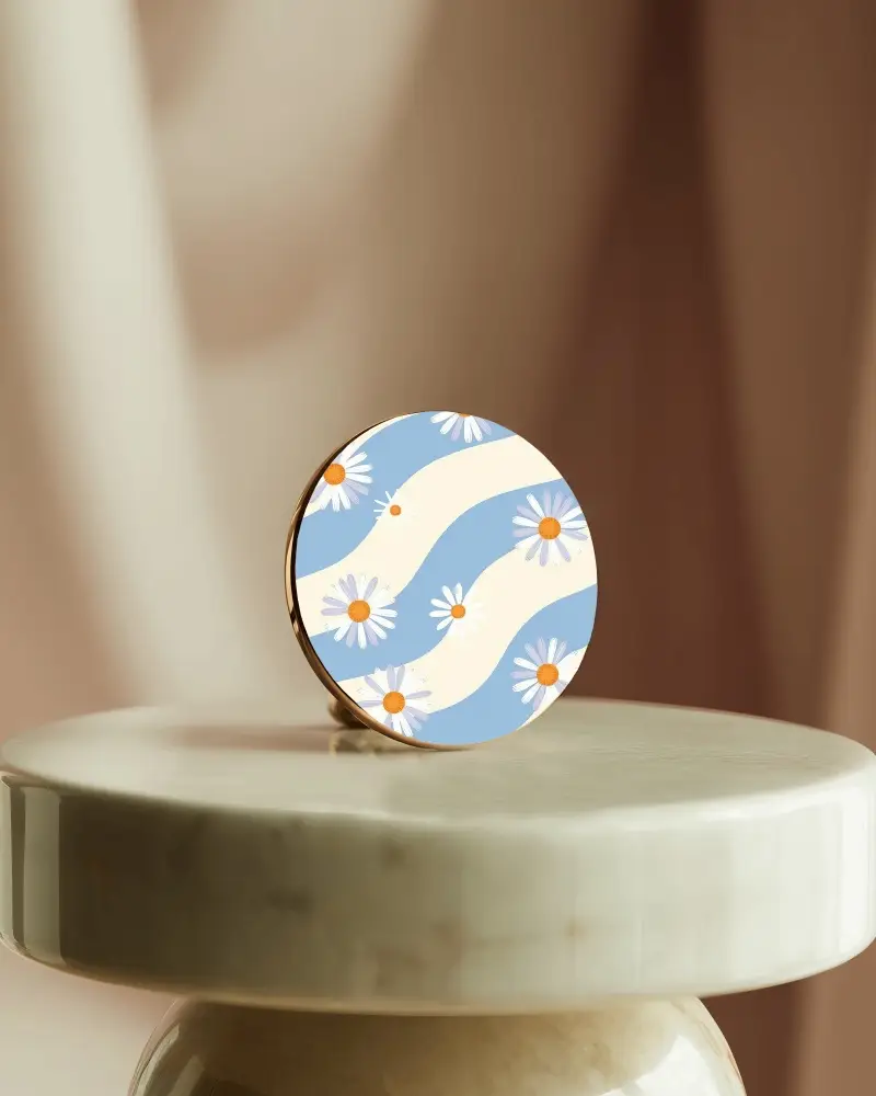 Minimalistic Round Black Earring Resting On White Marble Table With Soft Light