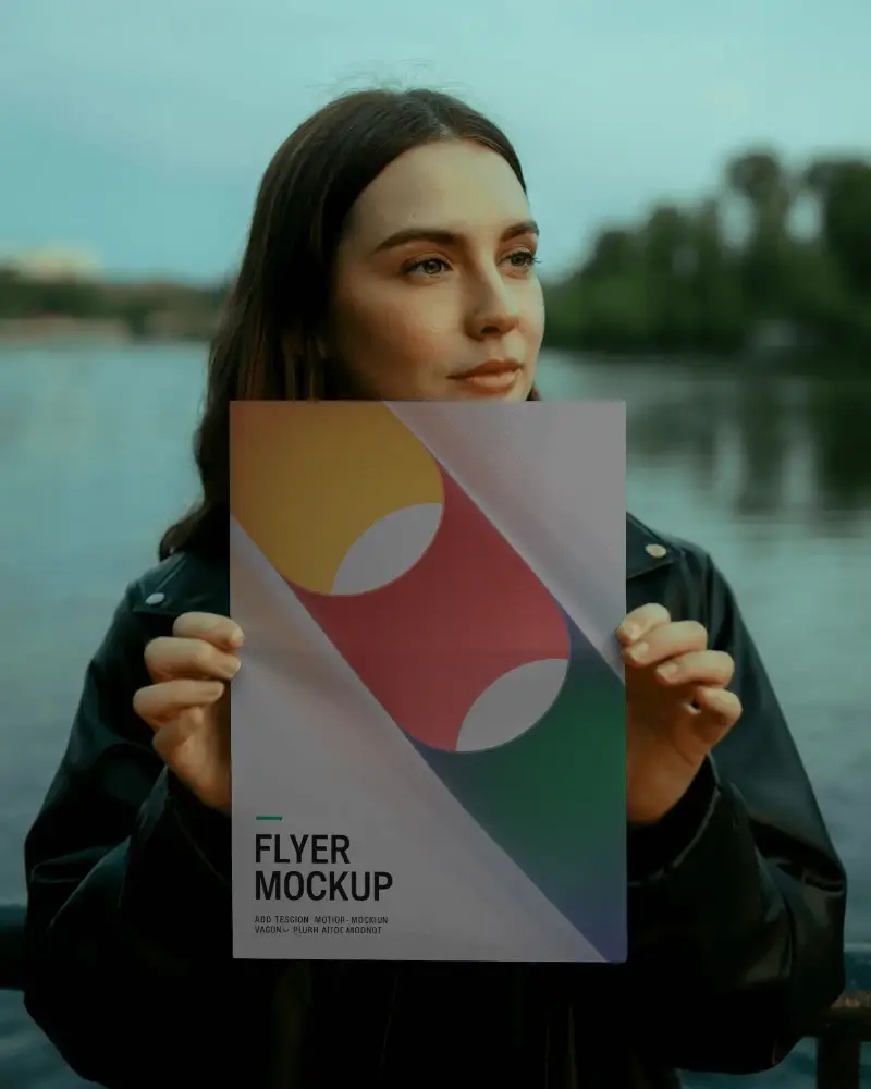 woman-holding-blank-flyer-mockup-outdoor-lake-background