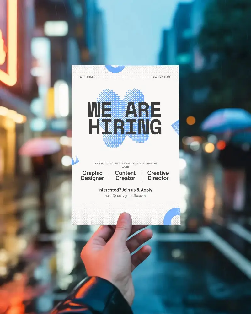 Hand Holding Blank Flyer Mockup Over Rainy Cityscape Night Background For Advertising