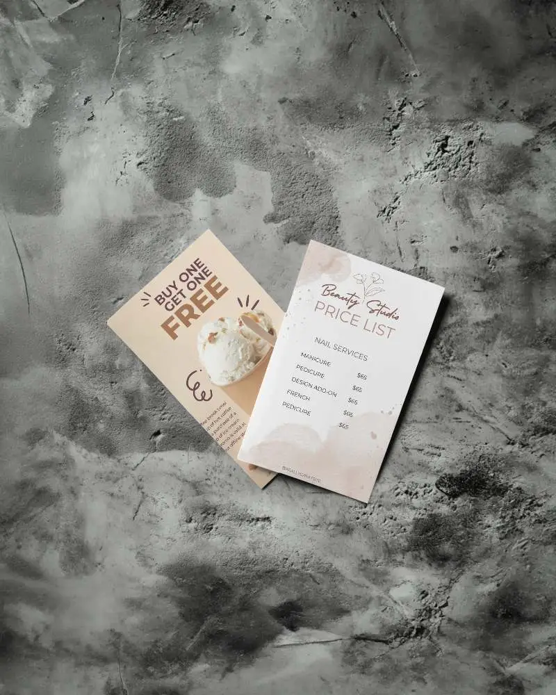 Artistic Angled Flyer Pair Mockup Against Dark Textured Cement Background 0119