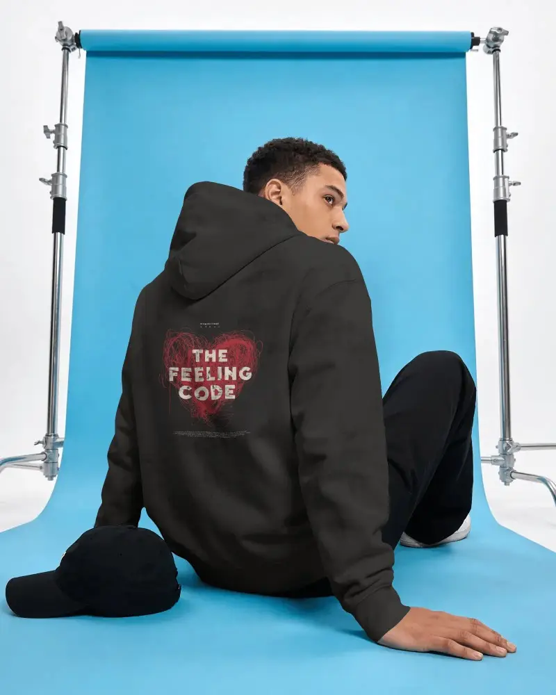 Back View Hoodie Mockup With Male Model Sitting Blue Backdrop Studio Setup Clean Light