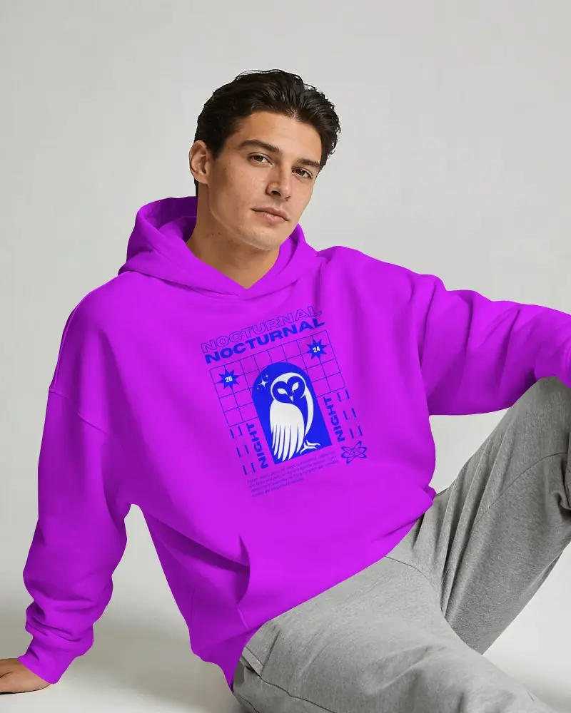 Studio Hoodie Mockup On Model With Relaxed Seated Pose And Clean Background
