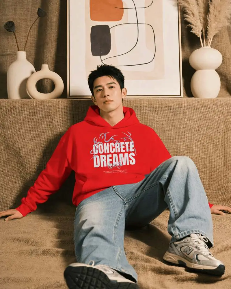 Lifestyle Hoodie Mockup On Model With Relaxed Sofa Pose And Cozy Interior Background