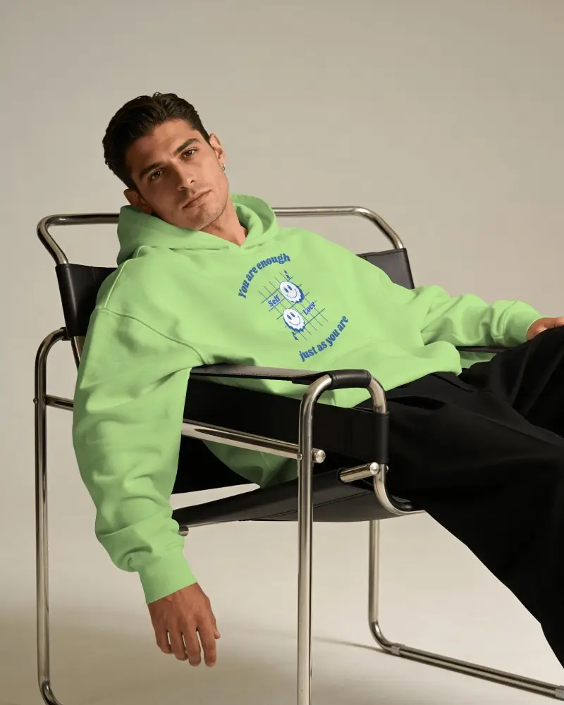 Printful Hoodie Mockup Male Model Reclining In Modern Metal Chair With Clean Editorial Studio