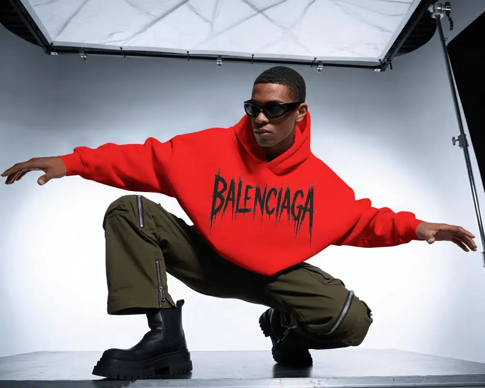 Amazon Hoodie Mockup Male Model Crouching In Dynamic Studio Pose With Professional Overhead