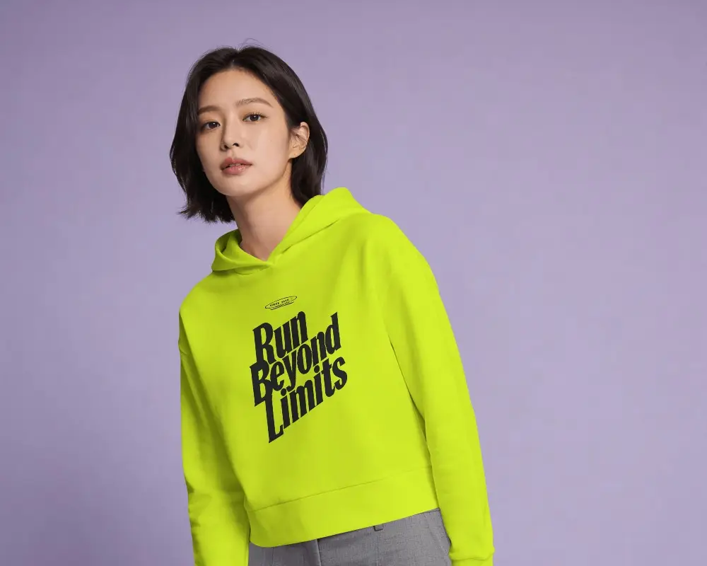 Front View Hoodie Mockup Female Model Leaning Slightly On Soft Purple Studio Lighting Composition