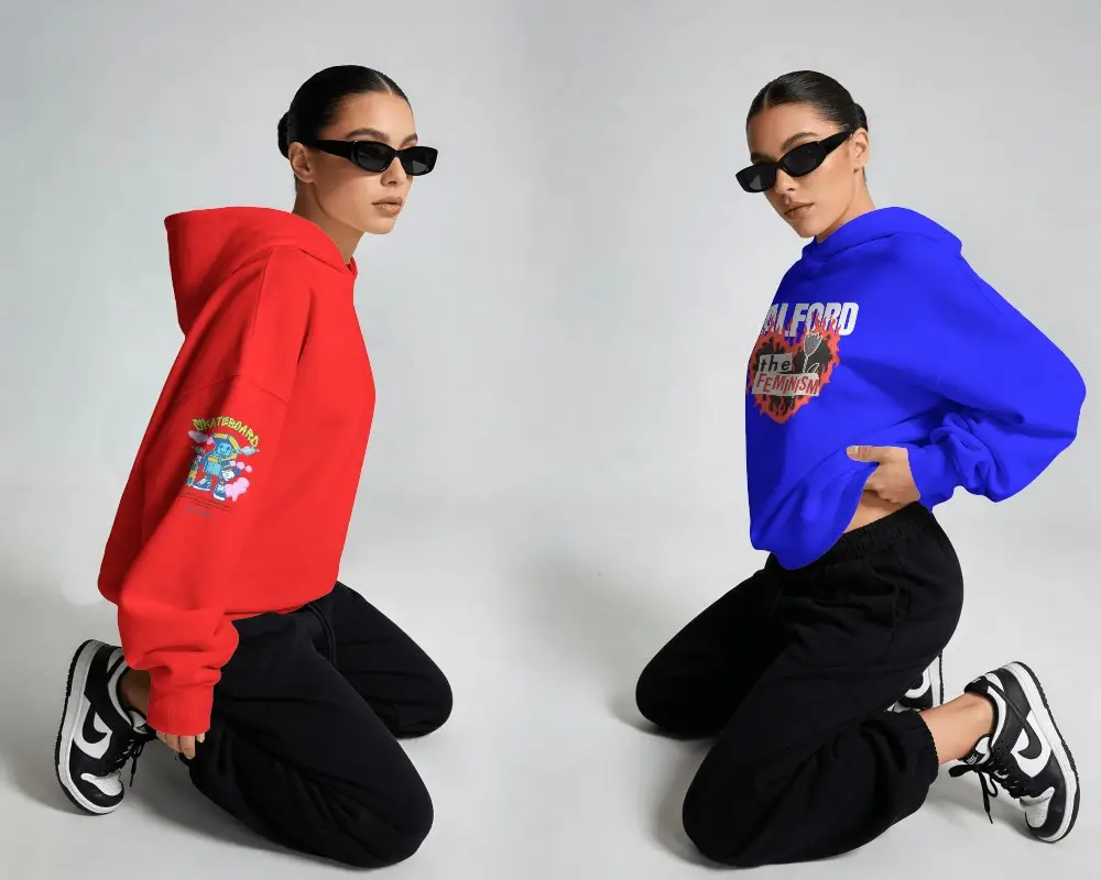 Dual Model Hoodie Mockup Female Models Kneeling In Minimal Studio With Sunglasses