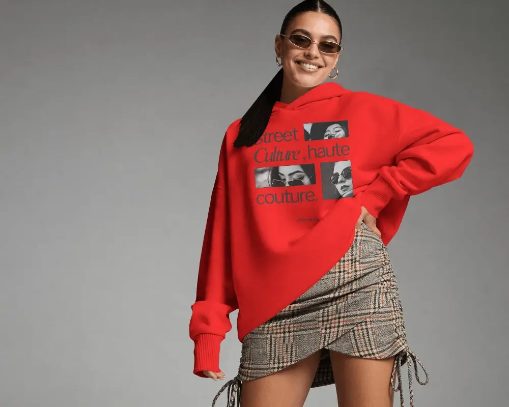 Smiling Female Model Hoodie Mockup With Sunglasses And Plaid Skirt In Clean Studio Setting