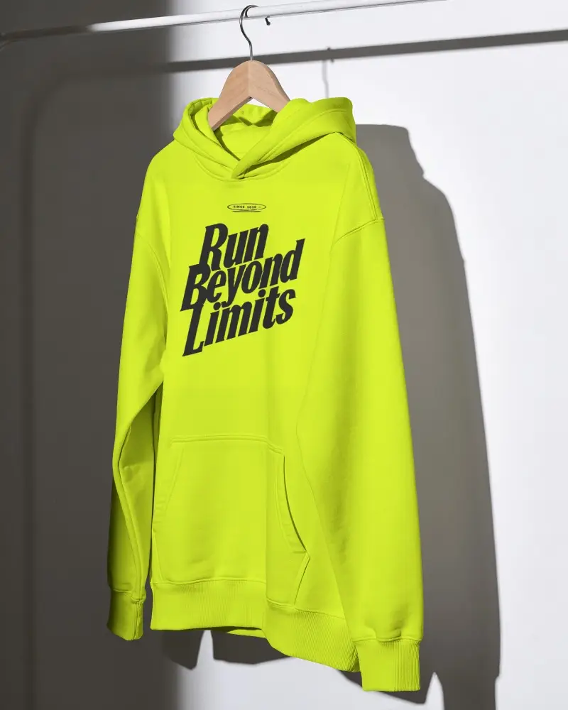 Hanging Hoodie Mockup On Wooden Hanger With Hard Directional Light And Sharp Wall Shadow