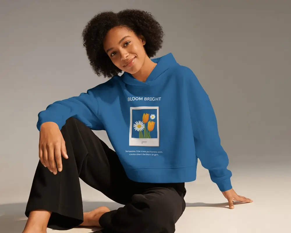 Seated Womens Hoodie Mockup With Curly Haired Model In Relaxed Floor Pose And Soft Studio Lighting