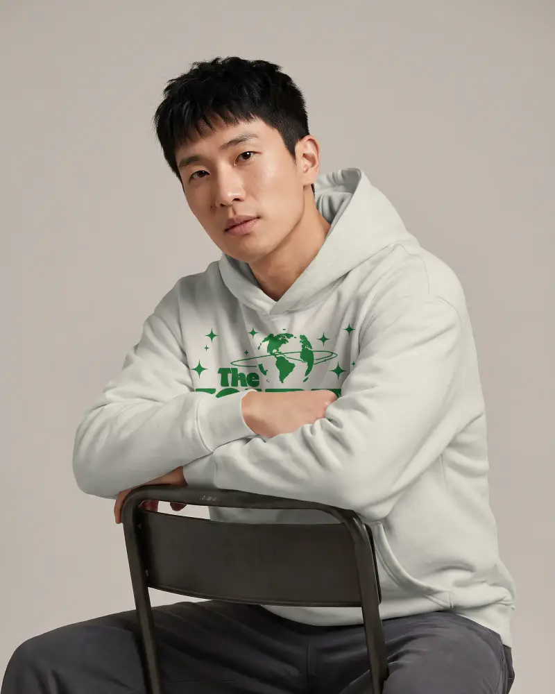 Casual Urban Hoodie Mockup For Men Facing Forward With Arms Crossed Over Chair Back