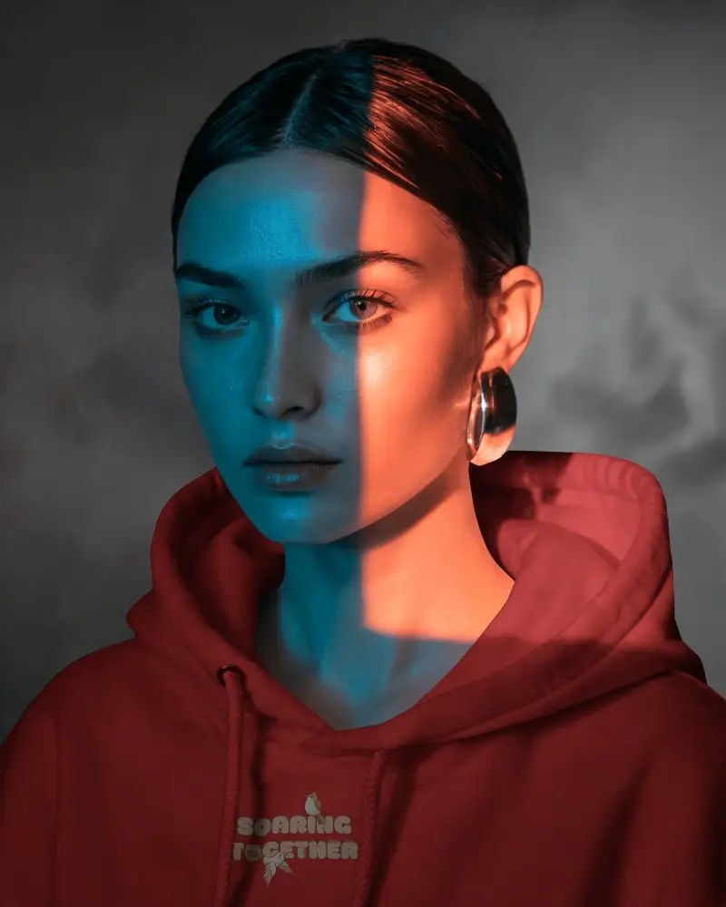 Moody Light Hoodie Mockup Female Model With Blue Orange Dual Toned Shadow Across Her Face