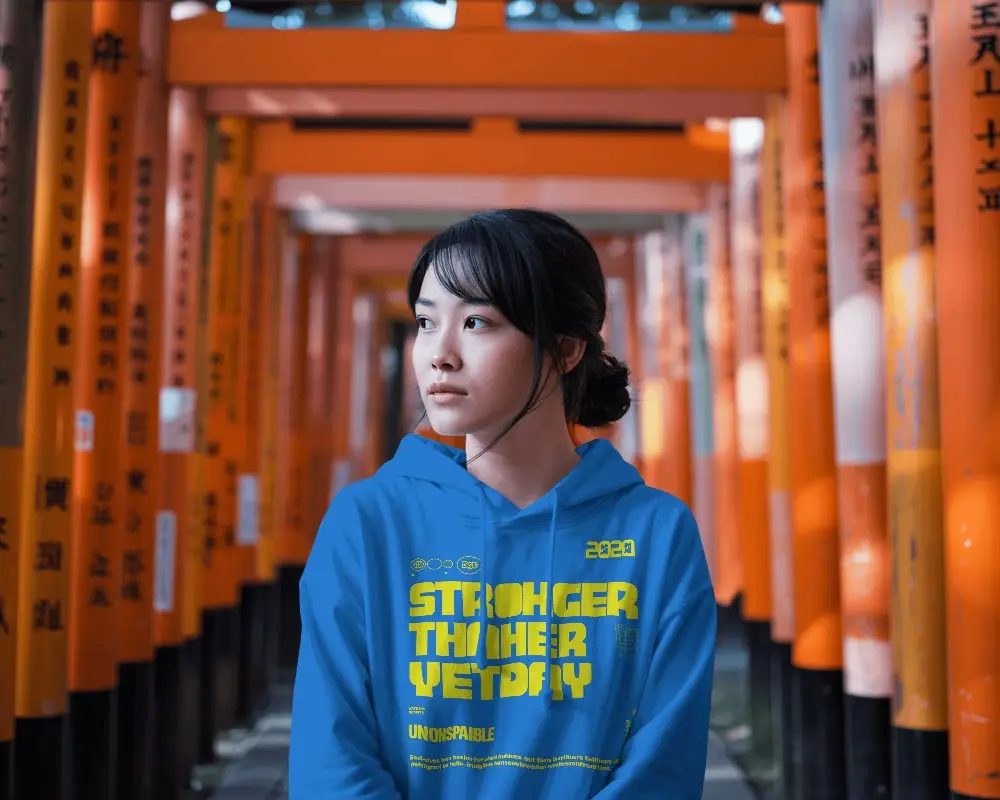 Cinematic Outdoor Hoodie Mockup Female Model Standing Between Orange Torii Gates Travel Lifestyle
