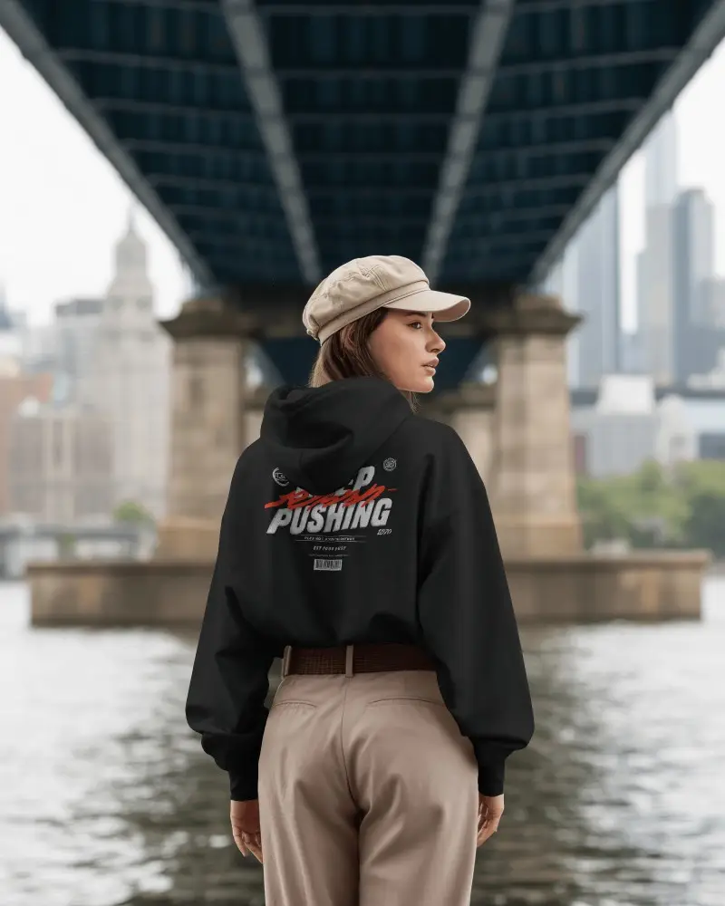 Urban Bridge Hoodie Mockup Female Model Standing By Riverfront Cityscape