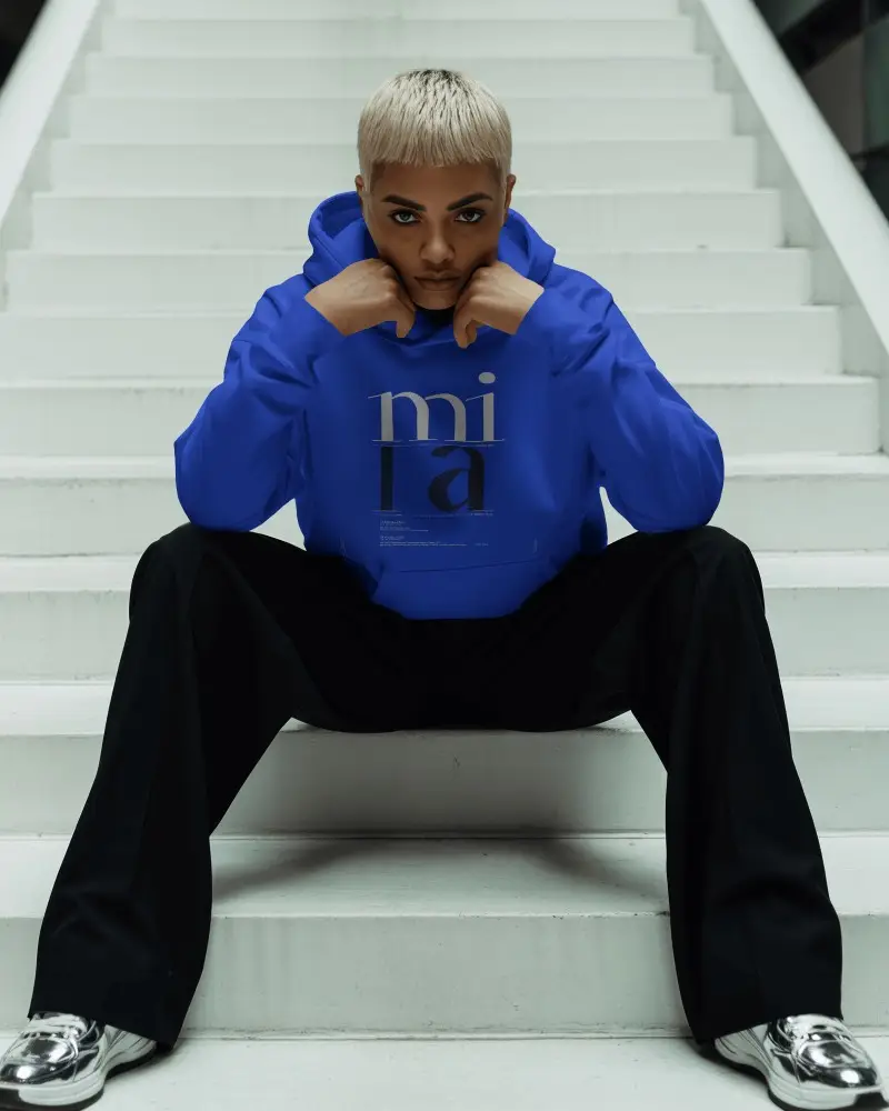 White Staircase Hoodie Mockup Model Seated In Centered Modern Setting