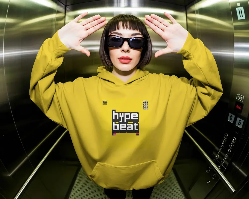 Urban Streetwear Hoodie Mockup Featured In Elevator Setting With Sunglasses Accessory