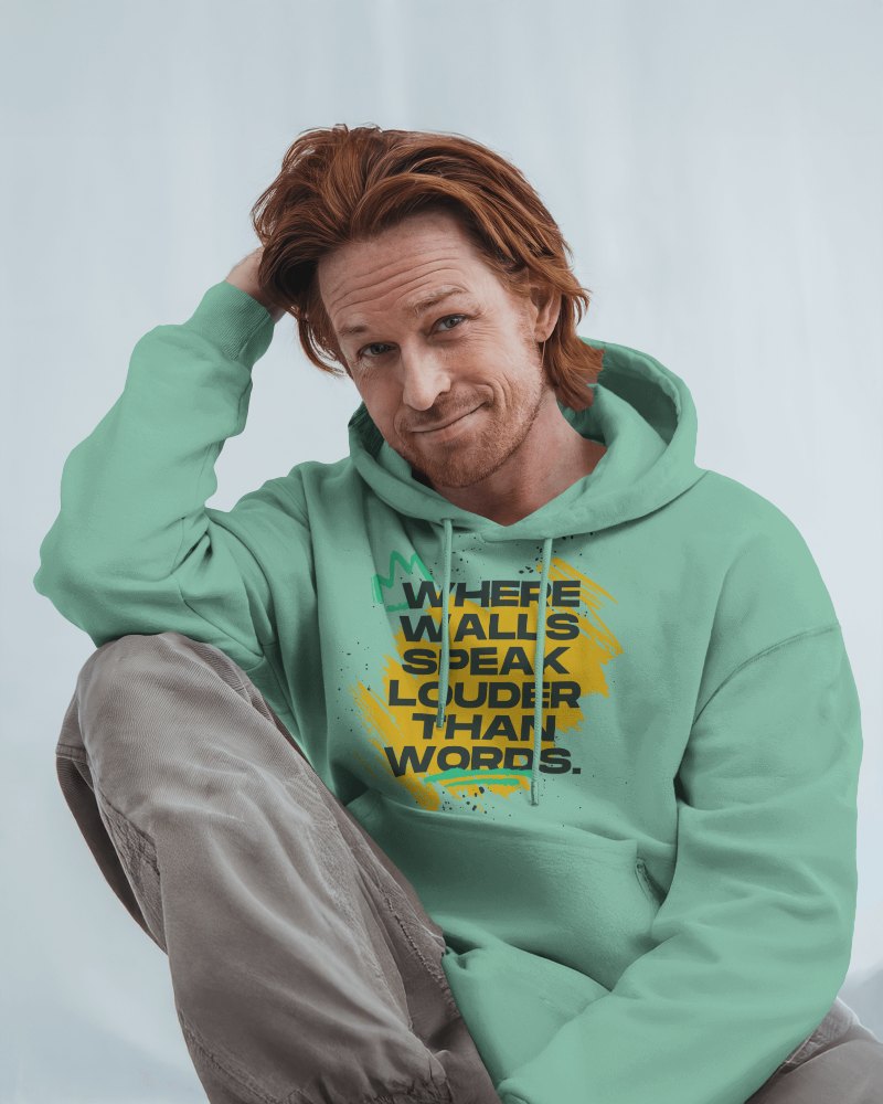 Creative Typography Hoodie Mockup Casual Male Model In Relaxed Pose Wearing Vibrant Graphic Statement Piece