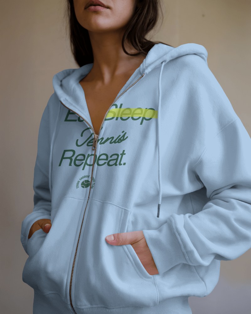 Pastel Blue Hoodie Mockup Female Model Presenting Unique Slogan Graphic Comfortable Casual Wea