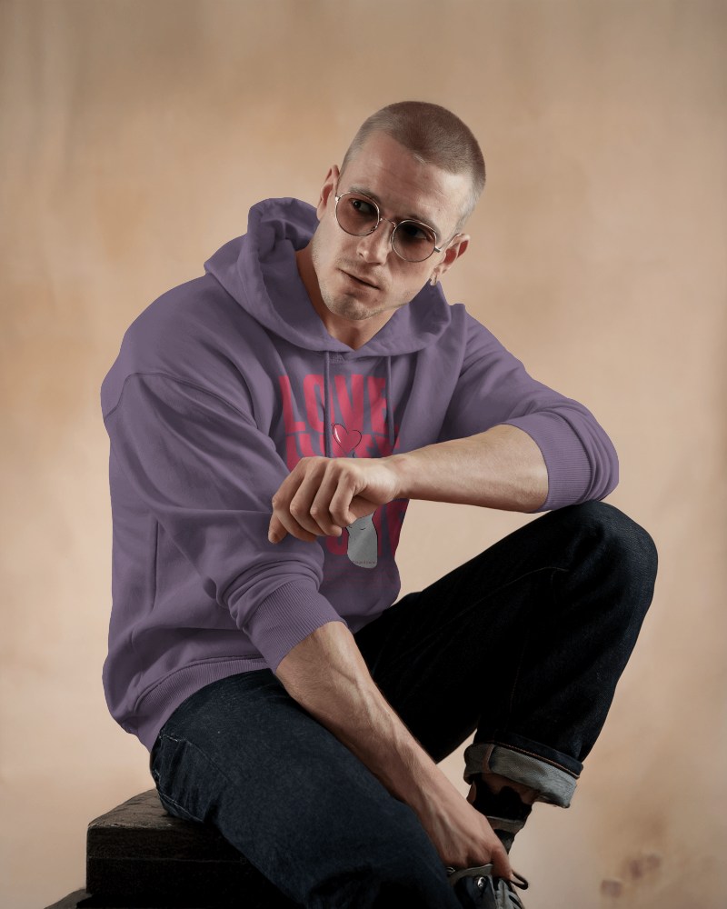 Light Purple Hoodie Mockup Male Model With Pink Text Graphic Sitting On Wooden Block Trendy Casual Wear