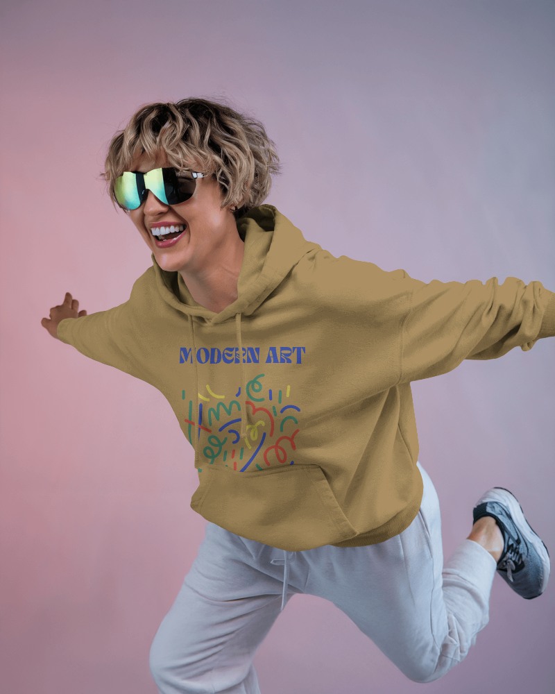 Lively Jump In Art Inspired Mustard Hoodie Mockup Female Model With Reflective Sunglasses
