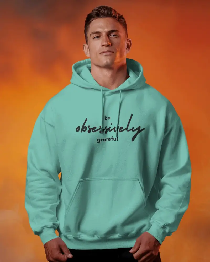 Dramatic Lighting Hoodie Mockup With Strong Male Model Posing In Front Of Smoky Sunset Toned Background
