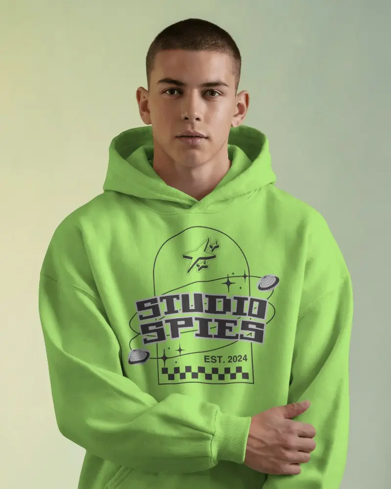 Minimalist Hoodie Mockup On Male Model Standing Confidently In Bright Soft Light And Colored Backdrop
