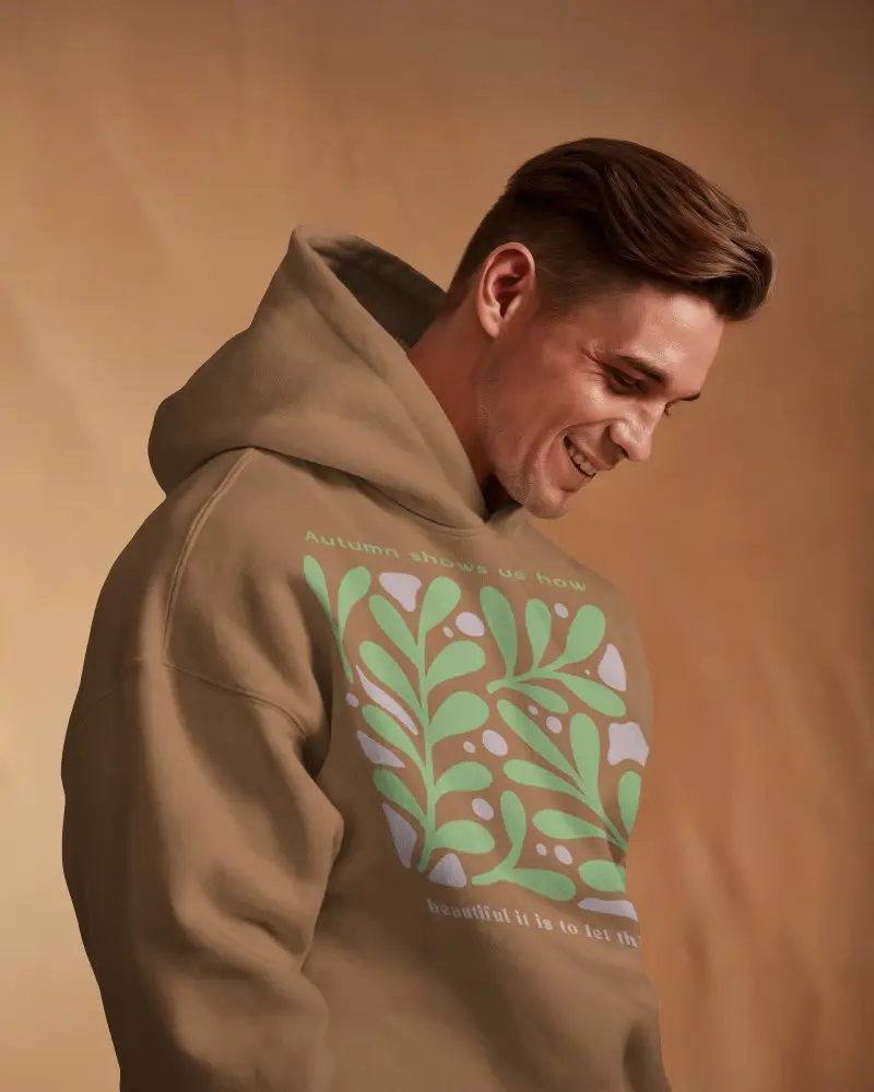 Natural Mood Hoodie Mockup Smiling Guy In Hoodie Against Beige Fabric Background