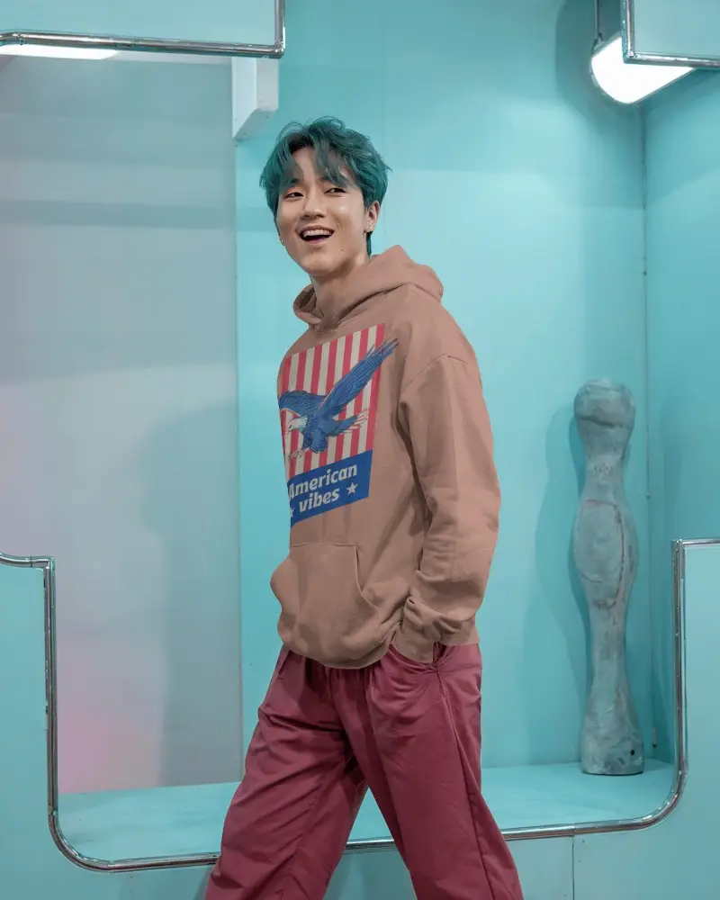 Pastel Blue Studio Hoodie Mockup Male Model Smiling In Modern Playful Setting