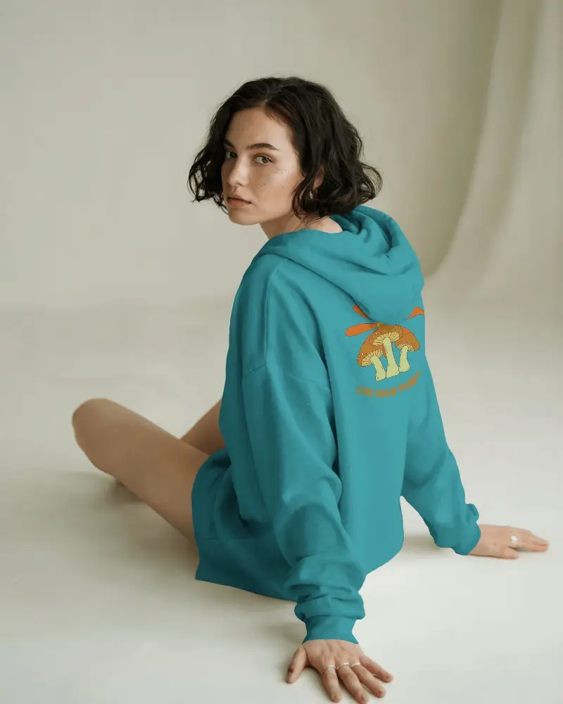 Casual Woman Sitting In Studio With Hoodie Mockup For Custom Design