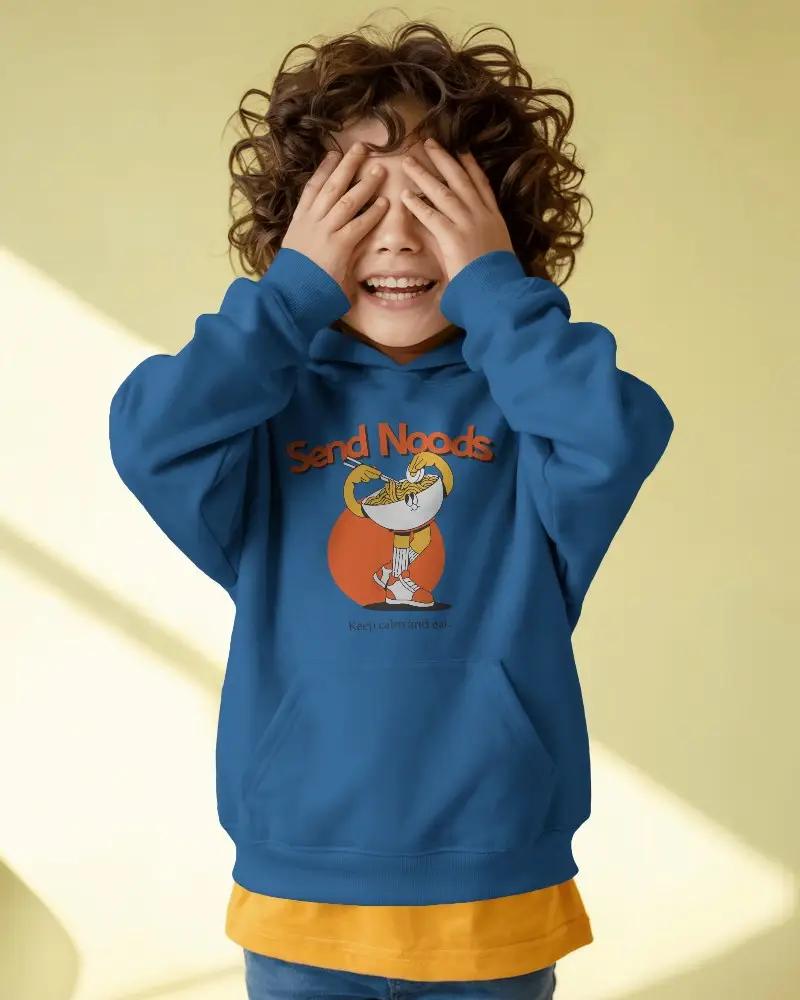Playful Child Presenting A Casual Hoodie Mockup With Custom Design Space Against Pastel Background