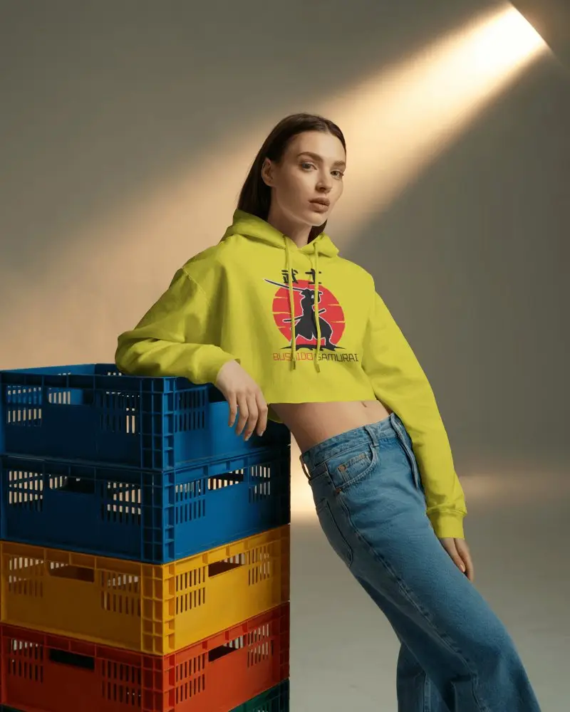 Cropped Hoodie Mockup Female Model Leaning On Colorful Crates Under Soft Spotlight