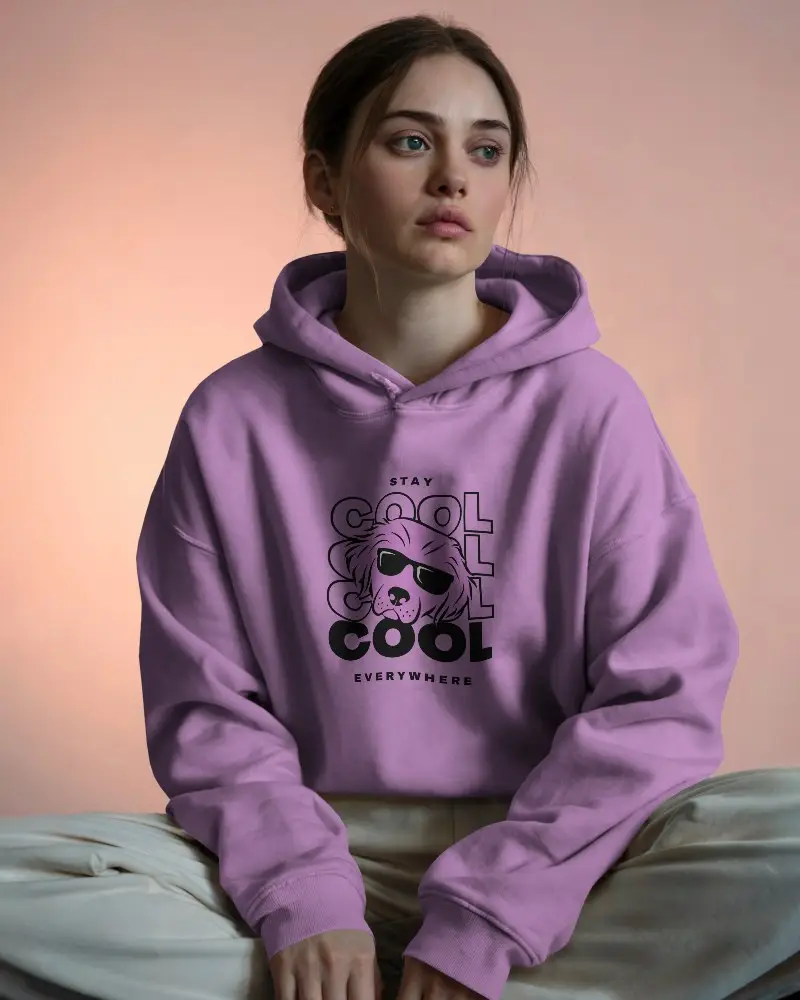Cozy Indoor Hoodie Mockup Female Model Sitting Cross Legged In Soft Light Against Blush Gradient Background 0600