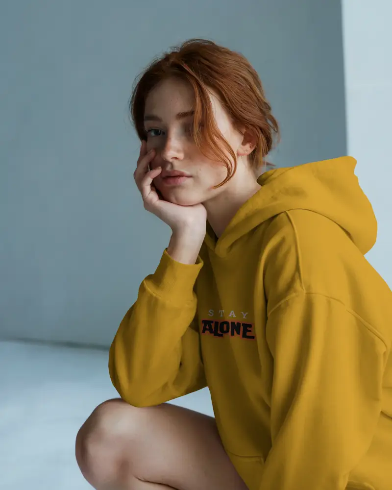 White Hoodie Mockup Female Model Sitting In Soft Blue Studio Moody Natural Lighting Cozy Fit Design On Front