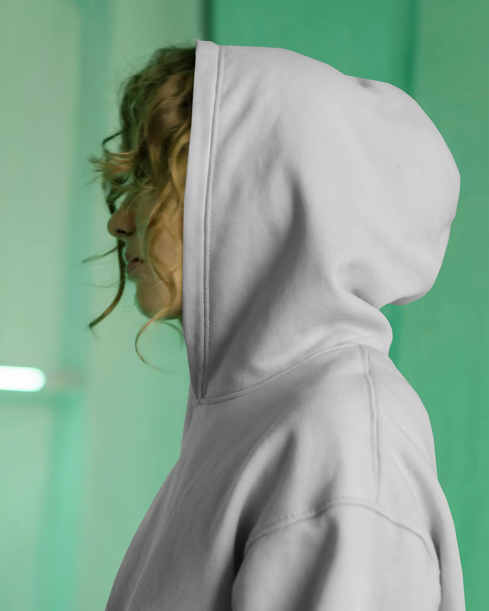 White Hoodie Mockup Side Profile Female Model Hood Up Design On Hood Close Up Soft Green Background Realistic Fabric Folds