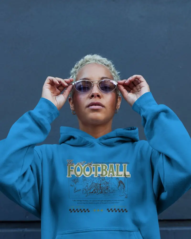 Urban Street Style Hoodie Mockup Confident Female Model Adjusting Sunglasses Against Navy Wall Modern And Edgy Vibe