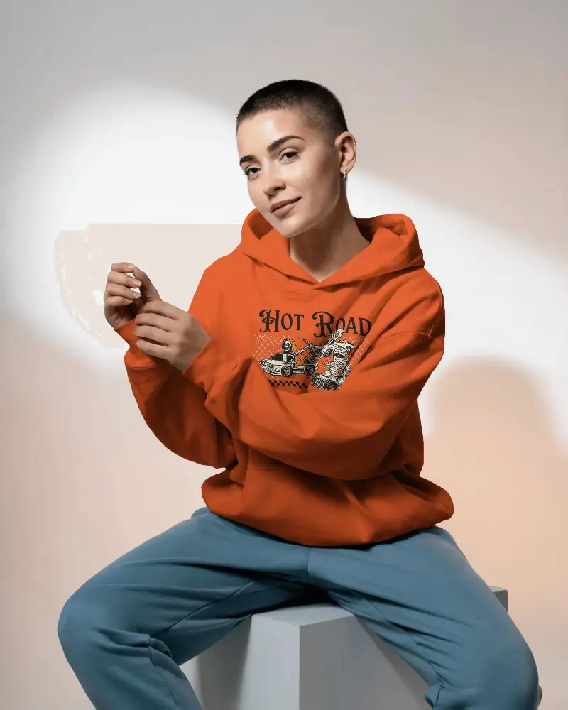 Relaxed Fit Hoodie Mockup Featuring Buzzcut Model In Seated Pose With Minimal Studio Lighting For Bold Brand Identity