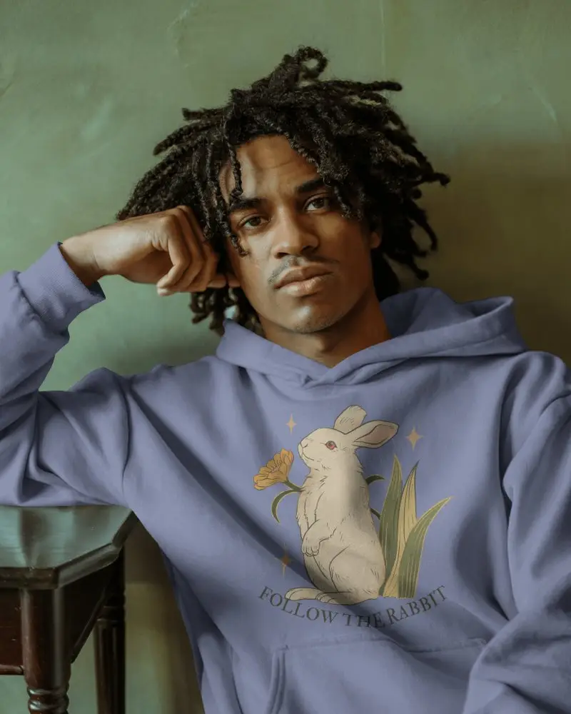 Urban Casual Hoodie Mockup Male Model With Curly Hair Seated In Stylish Setting