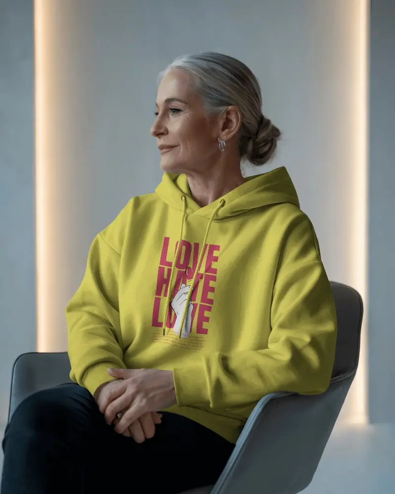 Elegant Seated White Hoodie Mockup Senior Female Model Looking Sideways In Modern Studio Soft Lighting Background 0708