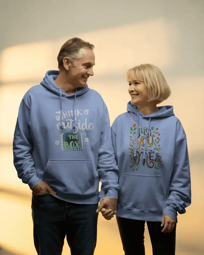 Warm Lit Hoodie Mockup Senior Couple Holding Hands Smiling In Studio Setting
